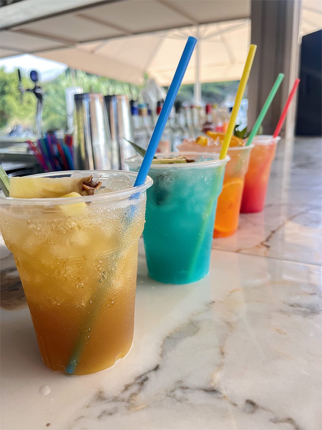 Four cocktails lined up on the marble bar